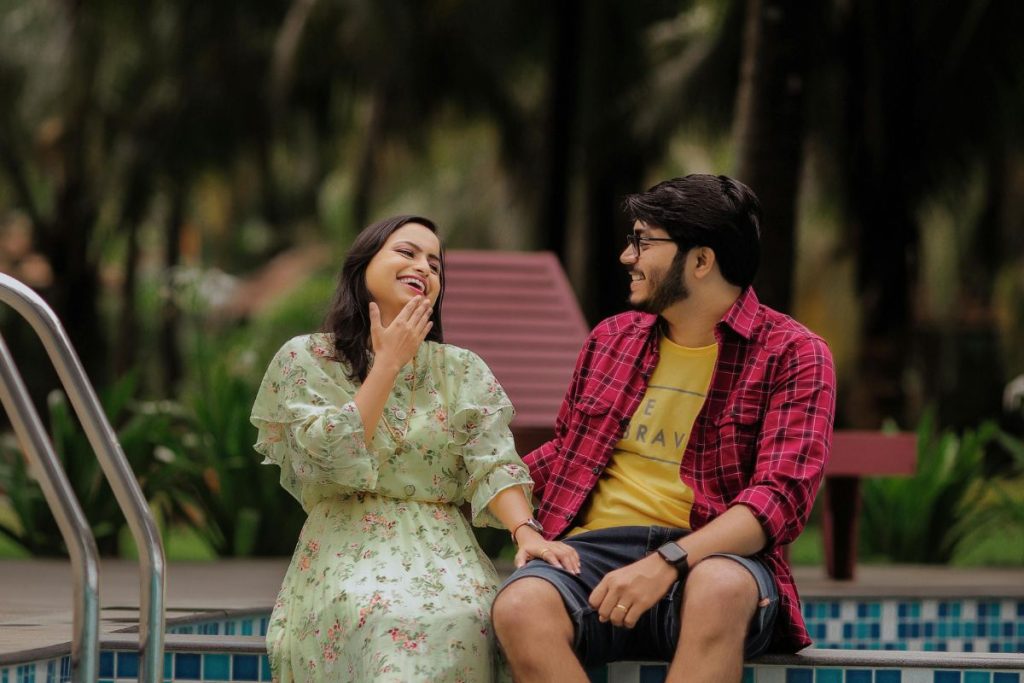 couple relaxing by resort swimming pool