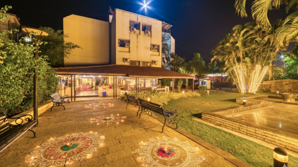 A stunning shot of Hotel Ashwin Igatpuri's exterior, highlighting its beautiful architecture against the backdrop of mountains