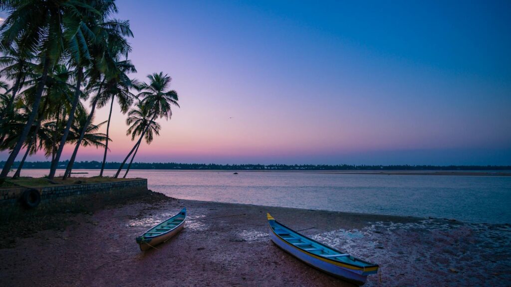 Beautiful sunset at Alibaug beach with coconut trees