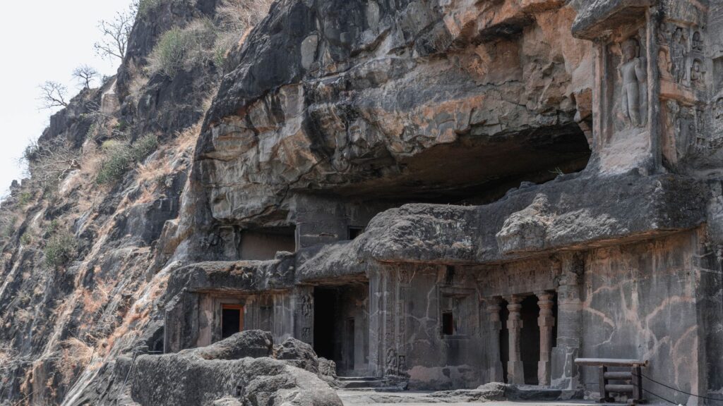 Ancient rock-cut Buddhist Kondana Caves surrounded by greenery near Karjat
