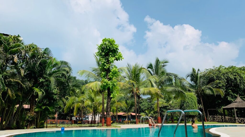Families enjoying a swimming pool at a resort in Igatpuri during summer holidays