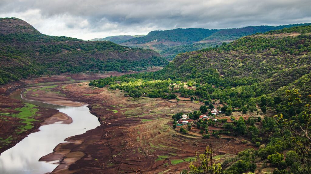 Lush green misty mountain valley and cascading waterfall in Igatpuri during monsoon