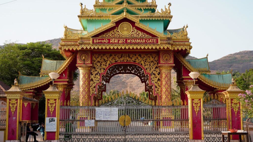 Ornate golden and green temple gate with intricate carvings.